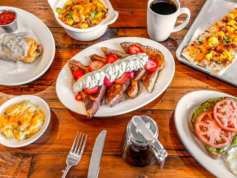 Breakfast plates with French toast, eggs, hashbrown casserole and coffee