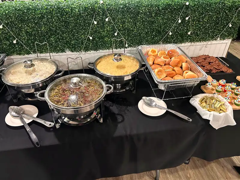 A catering buffet with chafing dishes of home-style sides
