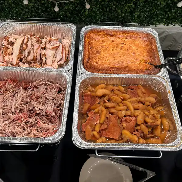 Catering trays of pulled pork and baked apples