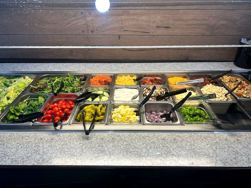 The Rooster’s Den salad bar stocked with fresh greens and toppings